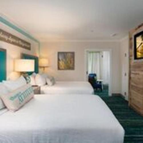 a hotel room with two beds and a room with at Margaritaville Resort Gatlinburg in Gatlinburg