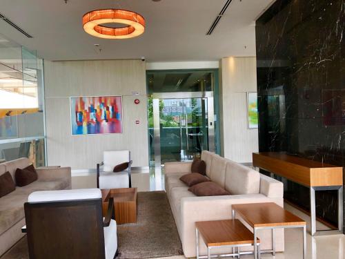a living room with a couch and a table at Splendid Suite 2 Bedroom @ Sunway & PJ in Petaling Jaya