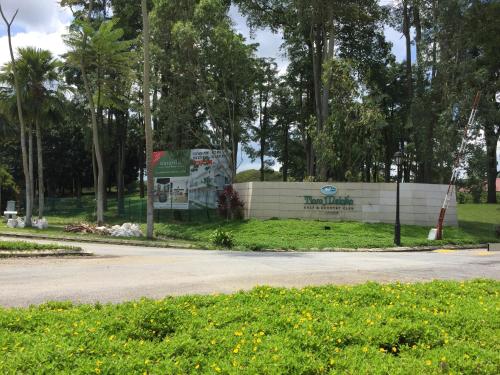 a park with a sign on the side of a road at Melaka Homestay Tiara Golf Resort in Malacca