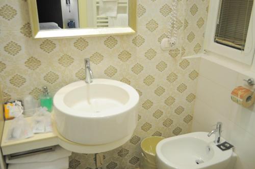 a bathroom with a sink and a toilet at Hotel Maggiore in Bologna