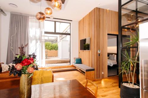 a living room with a couch and a table at Auckland City Spacious Loft - 4 Bedrooms & 2 Free Car Parks in Auckland