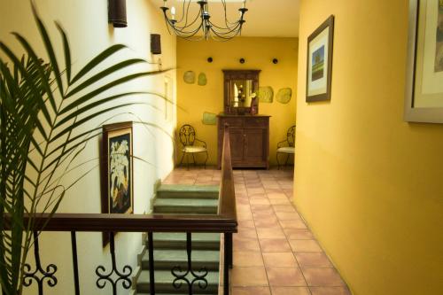 a living room filled with furniture and a staircase at Hotel Casa Divina Oaxaca in Oaxaca City
