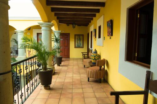 a hallway of a house with chairs and a balcony at Hotel Casa Divina Oaxaca in Oaxaca City