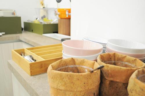 a kitchen counter with three cups of food on it at Hotel Maggiore in Bologna