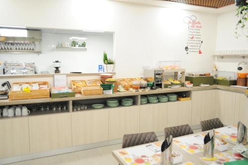 a restaurant with a counter with food on it at Hotel Maggiore in Bologna
