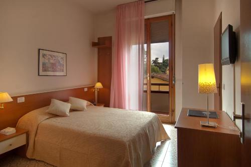 a hotel room with a bed and a window at Mio Hotel Firenze in Florence