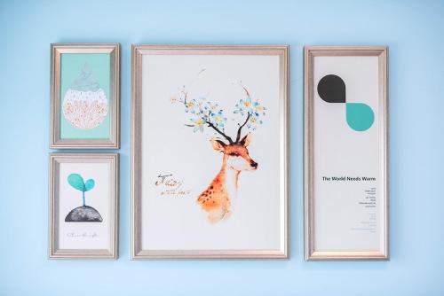 a group of four pictures on a wall with a giraffe at Henan Luoyang·Chanhe Hui Nationality Area· Locals Apartment 00144150 in Luoyang
