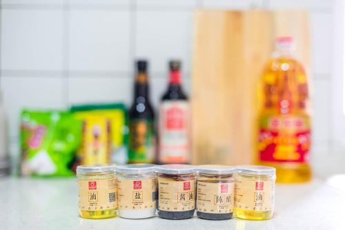 a row of jars of food sitting on a counter at Henan Luoyang·Chanhe Hui Nationality Area· Locals Apartment 00144150 in Luoyang