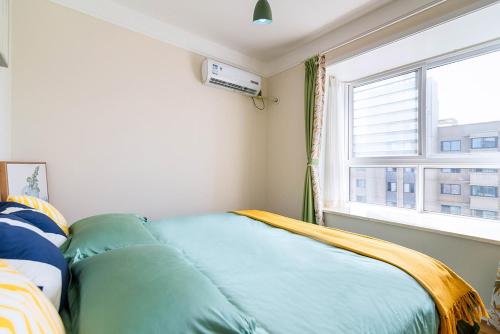 a bed in a room with a window at Henan Luoyang·Chanhe Hui Nationality Area· Locals Apartment 00144150 in Luoyang