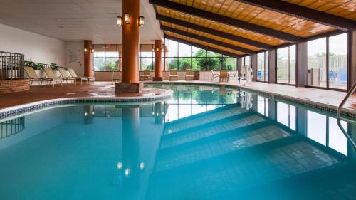a swimming pool with blue water in a building at Best Western Royal Plaza Hotel and Trade Center in Marlborough