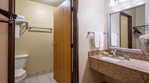 a bathroom with a sink and a toilet and a mirror at Best Western B R Guest in Zanesville