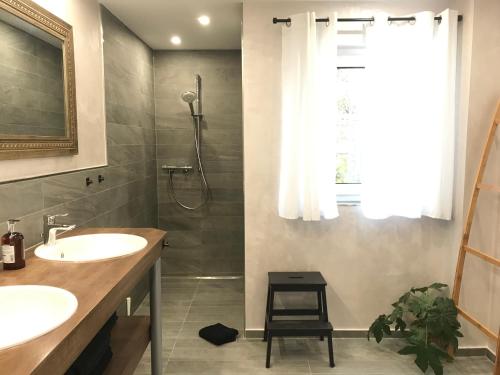 a bathroom with a shower and two sinks and a shower at Ferienhaus Albert in Owingen
