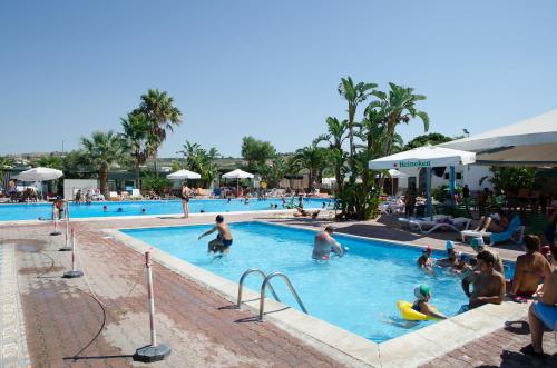 a group of people in a swimming pool at Kamemi Village & Camping in Ribera