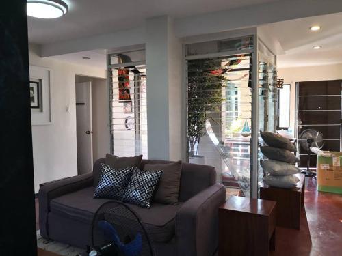 a living room with a brown couch and a table at Anabelle Residence in Dumaguete