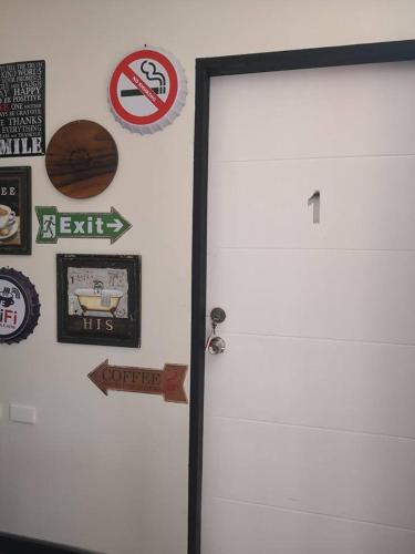 a white door with a bunch of signs on it at Anabelle Residence in Dumaguete