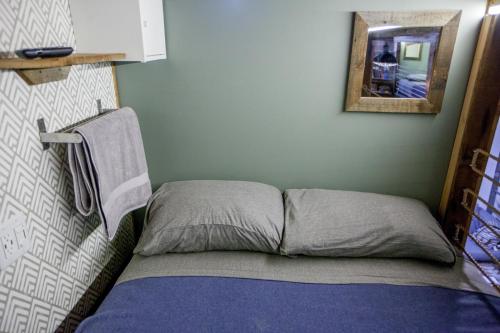 a bed in a room with a mirror on the wall at PodShare East Hollywood in Los Angeles