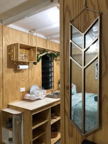 a kitchen with a mirror and a sink at SEA-green in Nelly Bay