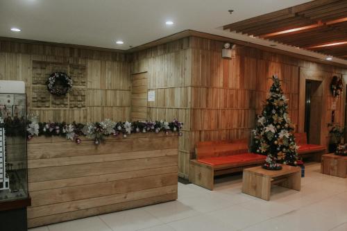 a room with a christmas tree in the middle at Unit 1109 Cityscape Residences in Bacolod