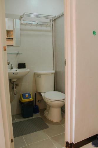 a bathroom with a toilet and a sink at Unit 1109 Cityscape Residences in Bacolod