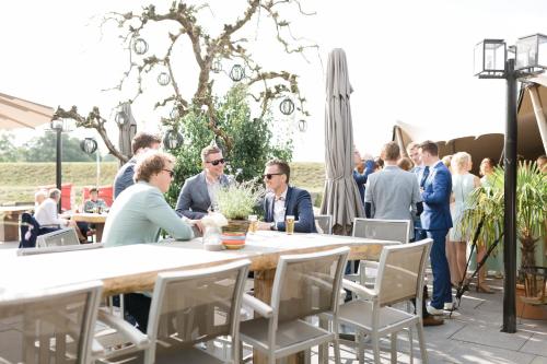 a group of people sitting at a table in a restaurant at Fort Resort Beemster in Zuidoostbeemster