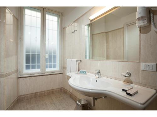 a bathroom with a sink and a mirror at Hotel Kennedy in Rome