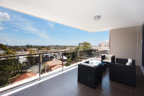 a living room with a large balcony with a view at The Junction Palais - Modern and Spacious 2BR Bondi Junction Apartment Close to Everything in Sydney