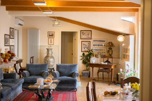 a living room with blue couches and a table at B&B Spring in Perugia