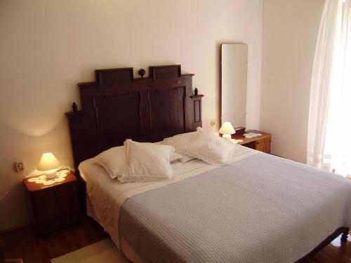 a bedroom with a large bed with white sheets and pillows at Villa Kate in Vis