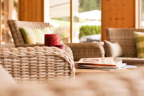a candle sitting on a table in a living room at Hotel Gasteigerhof in Neustift im Stubaital