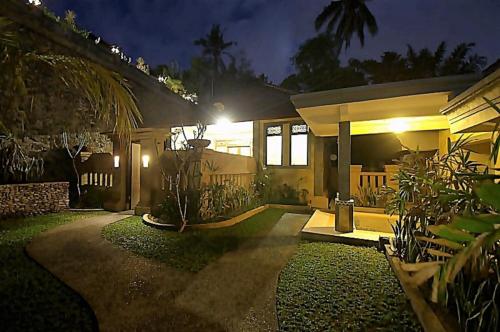 a house at night with a pathway leading to it at Kukuh House Ubud in Ubud