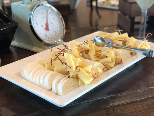 a plate of food with cheese and pasta on a table at Tzuba Hotel in Ẕova