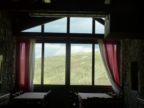 a room with two tables and a window with a view at Agriturismo Prato degli Angeli in Sassoleone