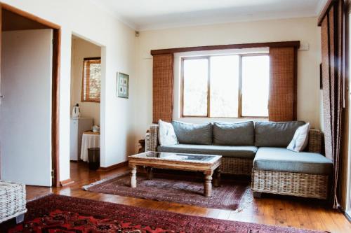 a living room with a couch and a coffee table at Cuckoo Ridge Country Retreat in Hazyview