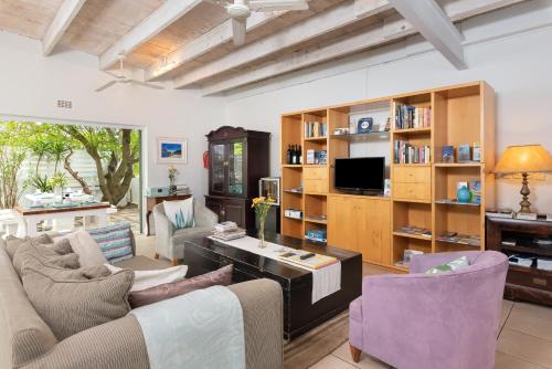 a living room with two couches and a tv at 61 on Camps Bay in Cape Town