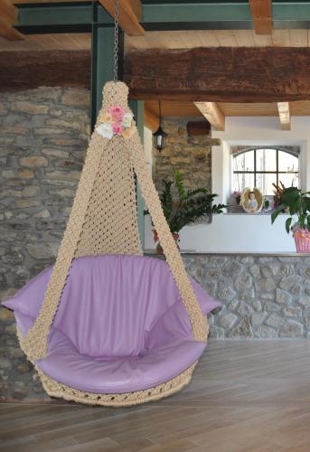 a crochet swing hanging from a ceiling in a room at Agriturismo Prato degli Angeli in Sassoleone