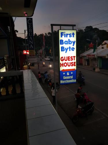 a first baby eyes guest house sign on a street at First Baby Bytes Guest House in Siquijor