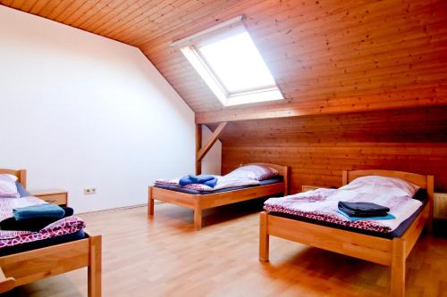 a attic room with two beds and a skylight at apartmondo Ferienwohnungen Solingen in Solingen