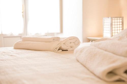 a bedroom with two towels laying on a bed at Corte di Bonifacio - Luxury Suites in Casarano