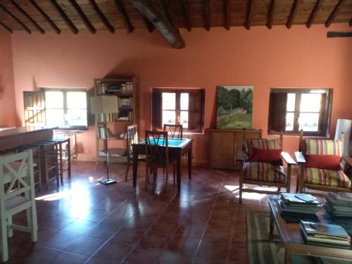 a living room with a table and chairs at El Jardin del Conde in Puerto de Béjar