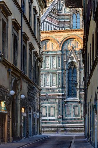 an alley in a city with a building at Palazzo Niccolini al Duomo Residenza D'Epoca in Florence