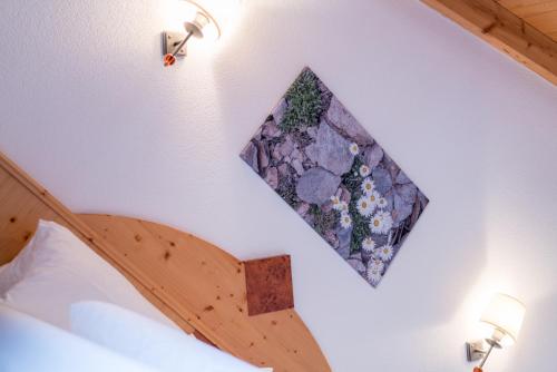 a picture on a wall above a bed in a room at Das Hochegg - Apartments in Obergurgl