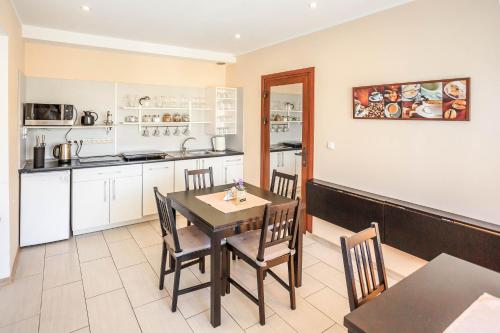 a kitchen and dining room with a table and chairs at Villavida in Poznań