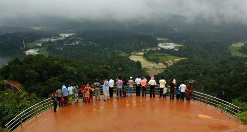 a group of people standing on the top of a tower at Dreams Home Estate Stay in Suntikoppa