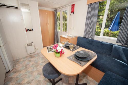a living room with a table and a blue couch at Toscana Holiday Village in Montopoli in Val dʼArno