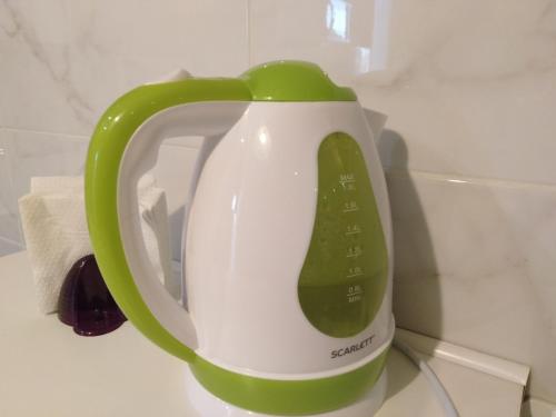 a green and white tea kettle sitting on a counter at Apartments Galactika in Oral