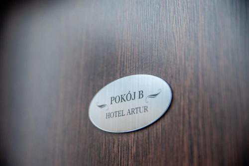 a sign on a wooden door with the words pocket b hotel appliance at Hotel Artur in Oświęcim