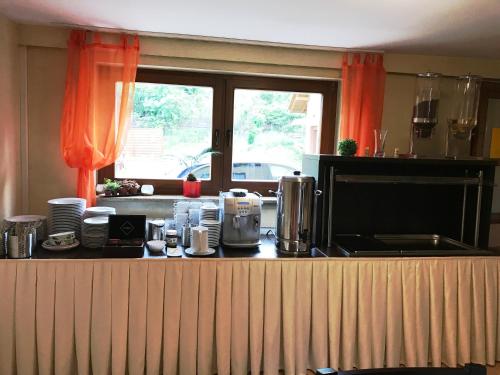 a kitchen with orange curtains and a counter top at Willa Nova in Wisła