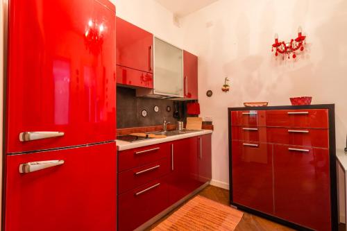 a kitchen with red cabinets and a red refrigerator at Doge's Pantheon & St.Mark School in Hidden Venice in Venice