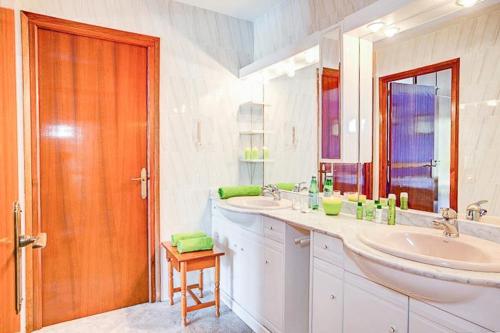 a bathroom with two sinks and a large mirror at Villa Cadí . Ref. 620 in Tamariu