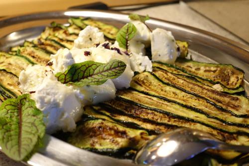 a plate of food on a table with a spoon at Hotel Bergland in Sillian